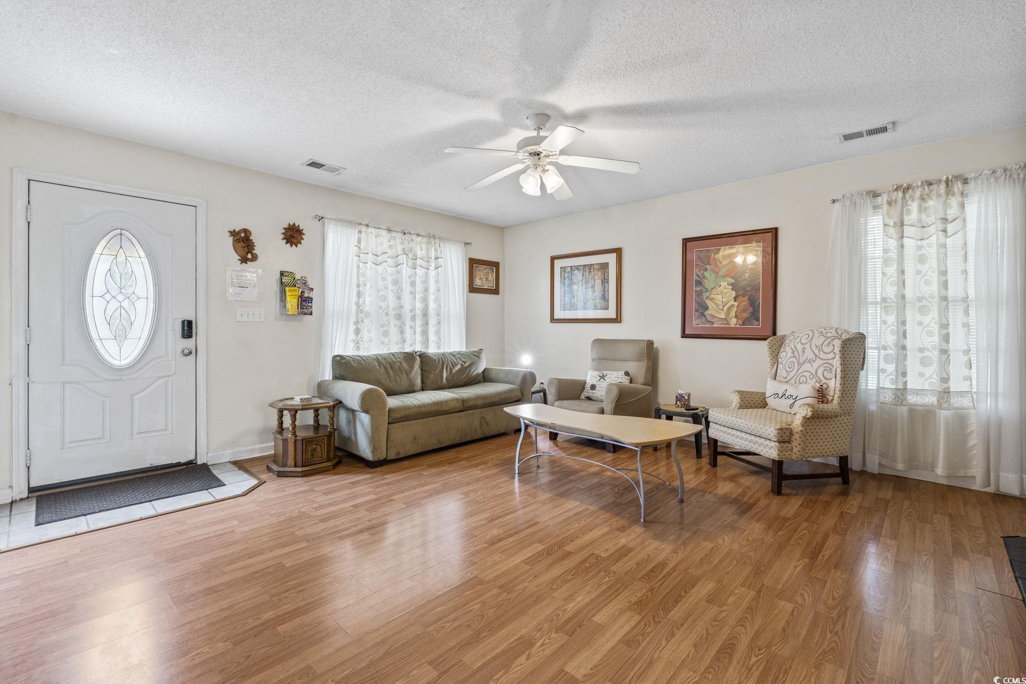 2405 Sherry Avenue Conway, SC 29527 - Photo 12 of 29 Living area featuring a textured ceiling, light wood-style floors, a ceiling fan, and healthy amount of natural light