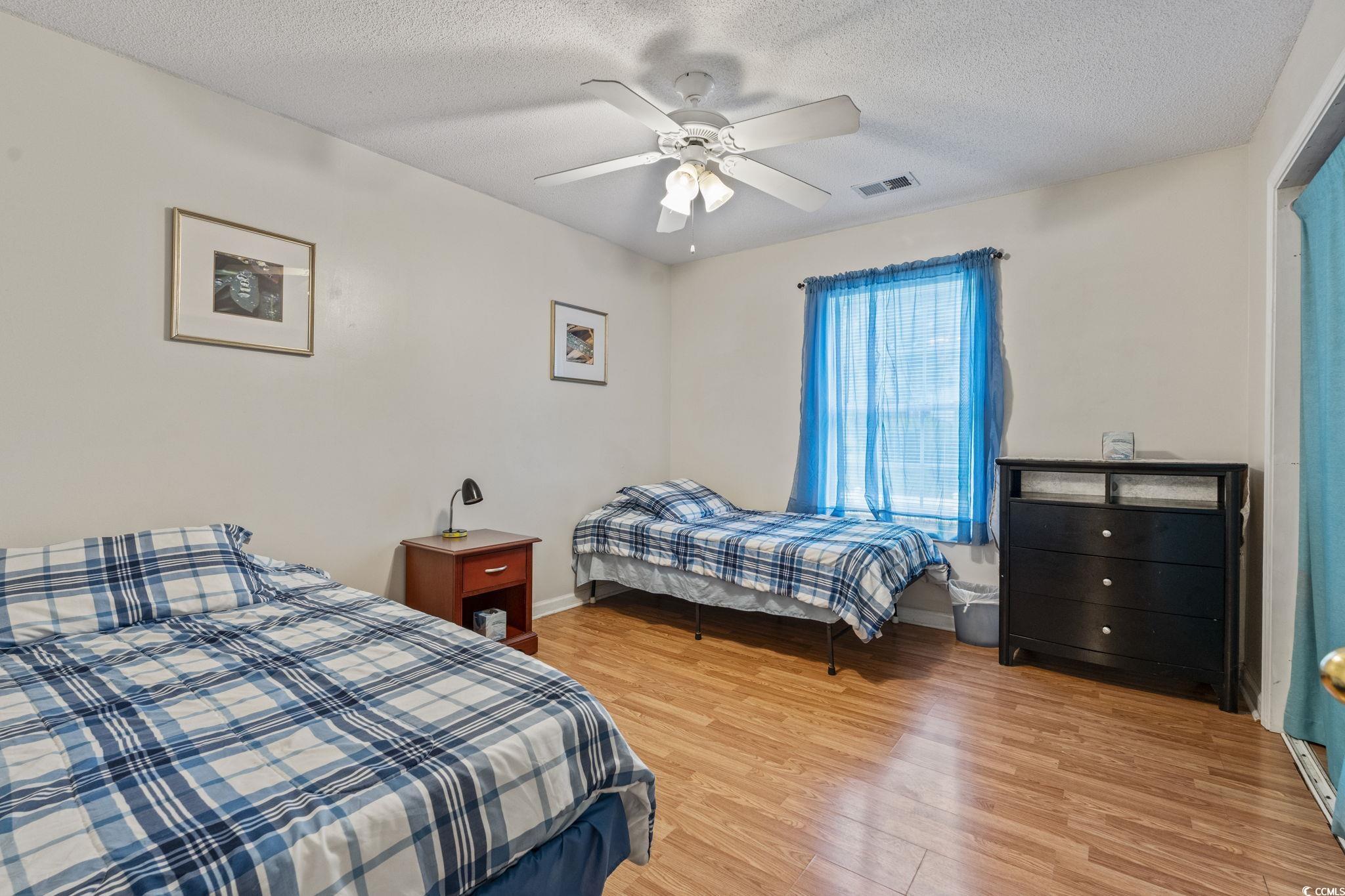 2405 Sherry Avenue Conway, SC 29527 - Photo 13 of 29 Bedroom featuring light wood-style floors, a textured ceiling, and a ceiling fan