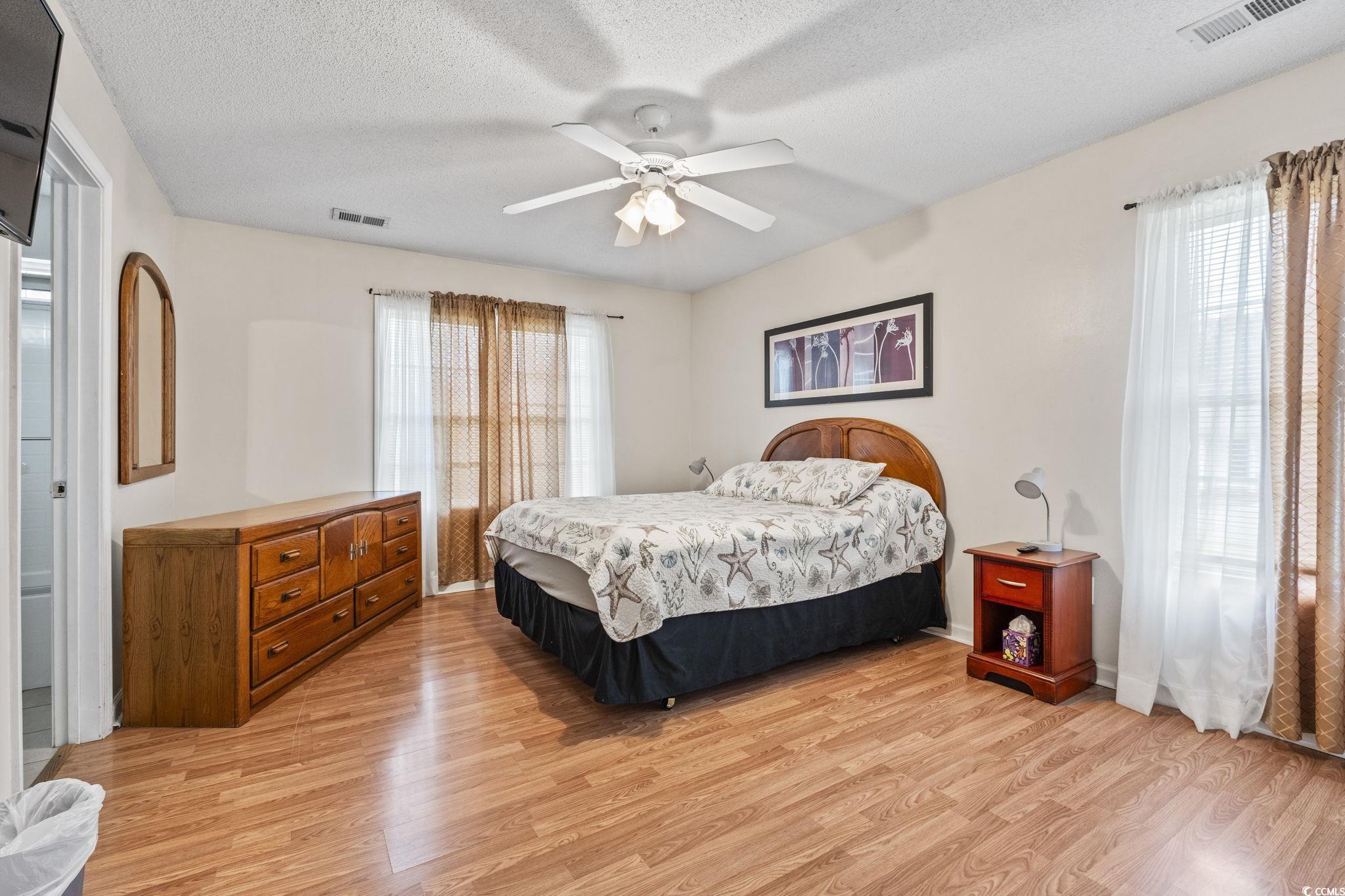 2405 Sherry Avenue Conway, SC 29527 - Photo 16 of 29 Bedroom with light wood-type flooring, multiple windows, a textured ceiling, and a ceiling fan