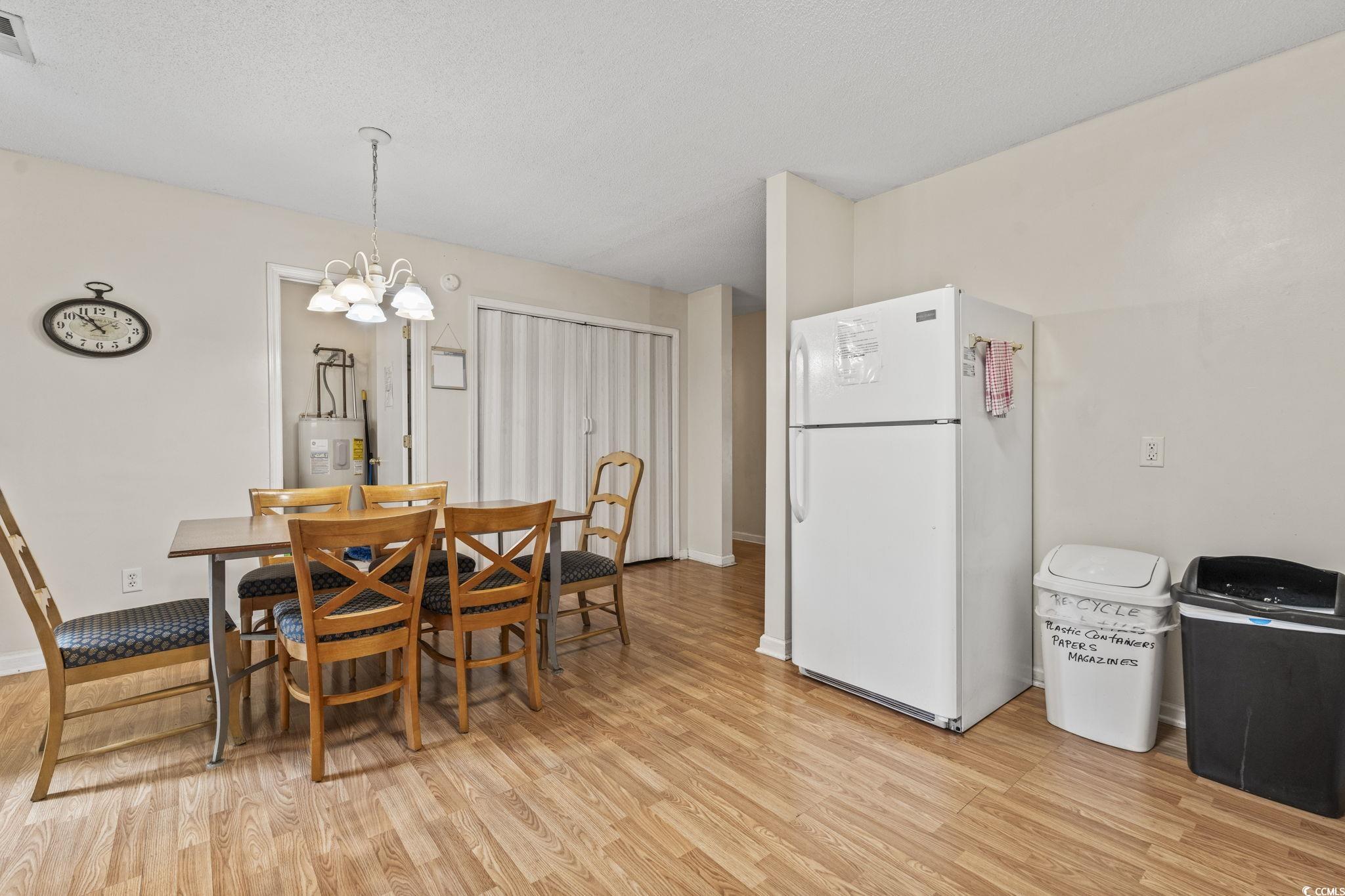 2405 Sherry Avenue Conway, SC 29527 - Photo 9 of 29 Dining space featuring light wood-style floors, a chandelier, and electric water heater