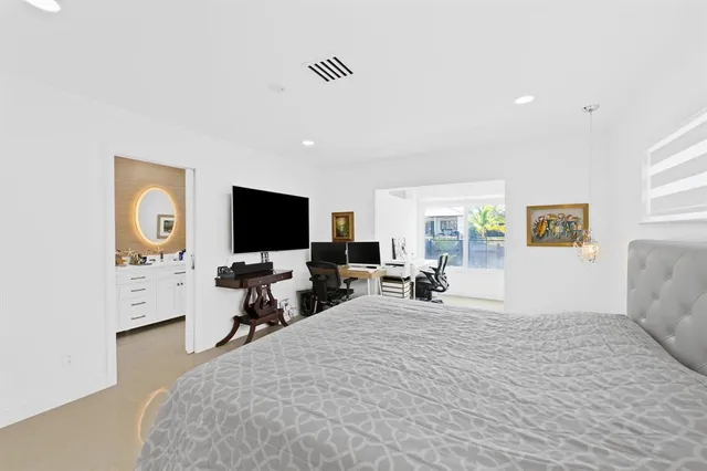 a bedroom with furniture and a flat screen tv