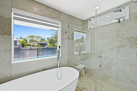 a bathroom with a tub and a shower