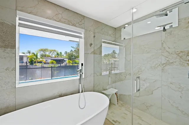 a bathroom with a tub and a shower