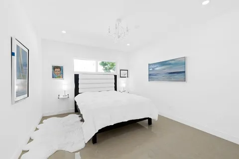 a bedroom with a bed and a night stand