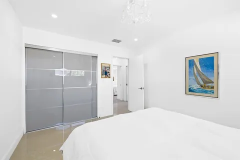 a bedroom with a bed and a painting on the wall