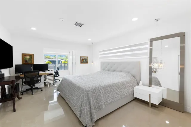 a bedroom with a bed couch and window