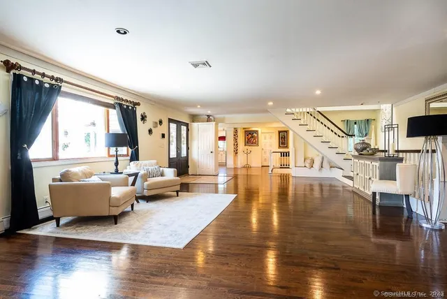 a living room with fireplace furniture and a wooden floor