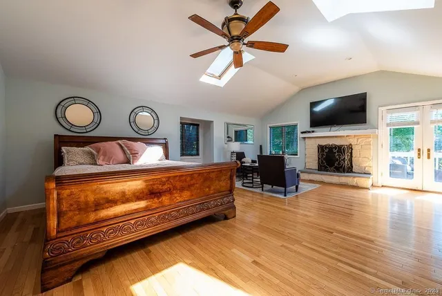 a bedroom with furniture fireplace and a window