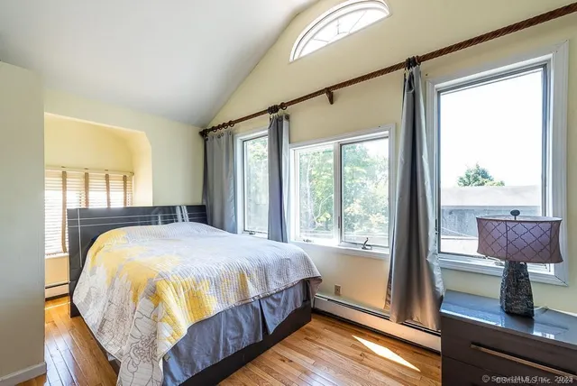 a spacious bedroom with a bed and a window