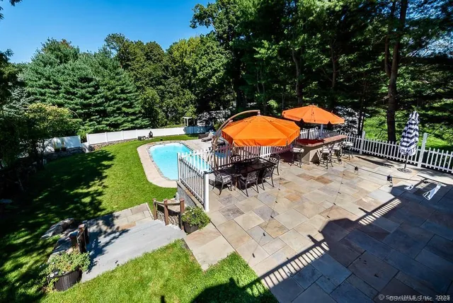 an aerial view of a house with a swimming pool patio and outdoor seating