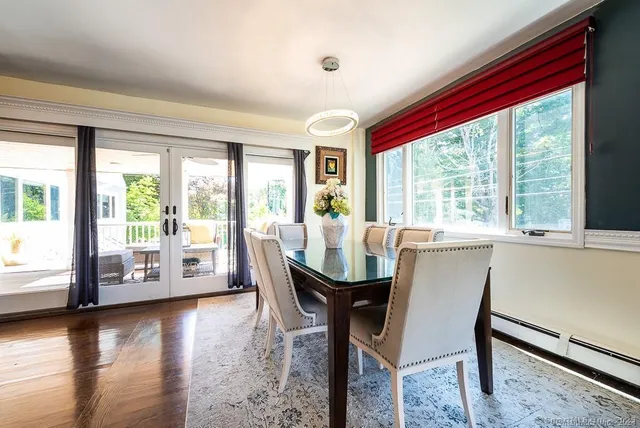 a dining room with furniture and wooden floor