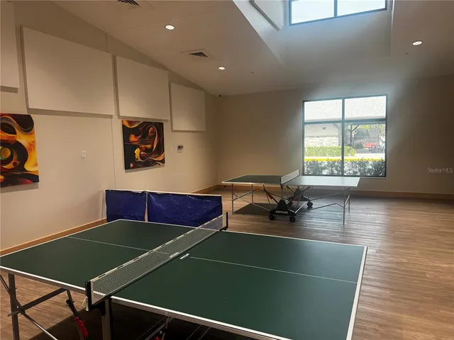 a room with pool table and windows