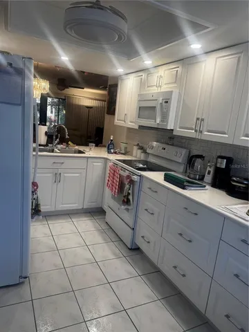 a kitchen with cabinets and appliances