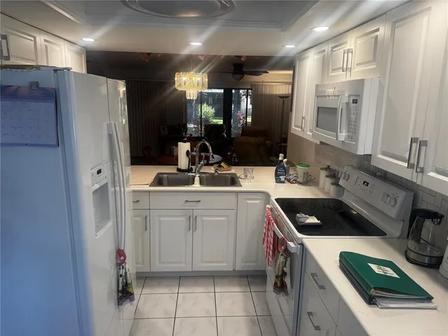 a kitchen with a sink stove and refrigerator