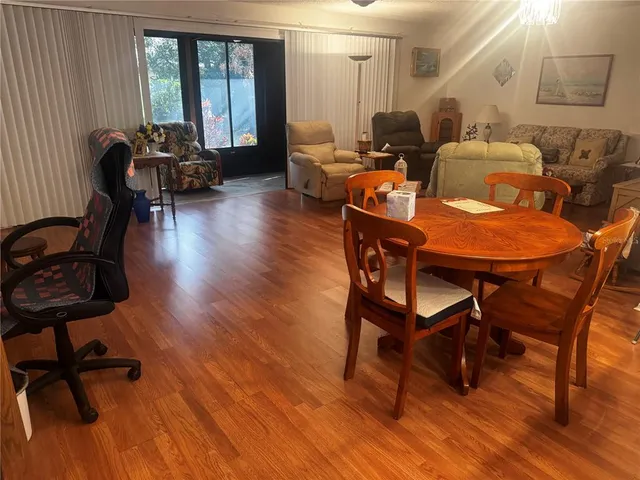 a living room with furniture a table and wooden floor