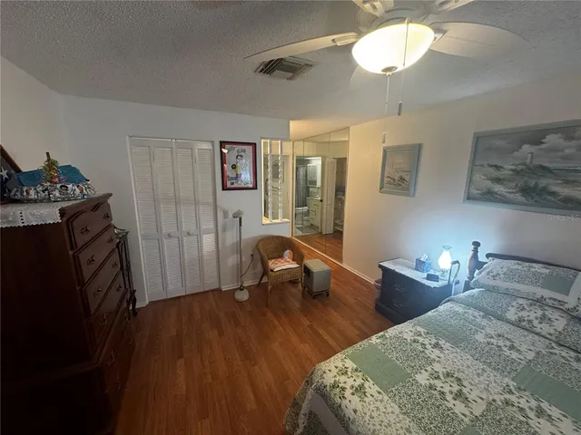 a bedroom with bed and a chandelier