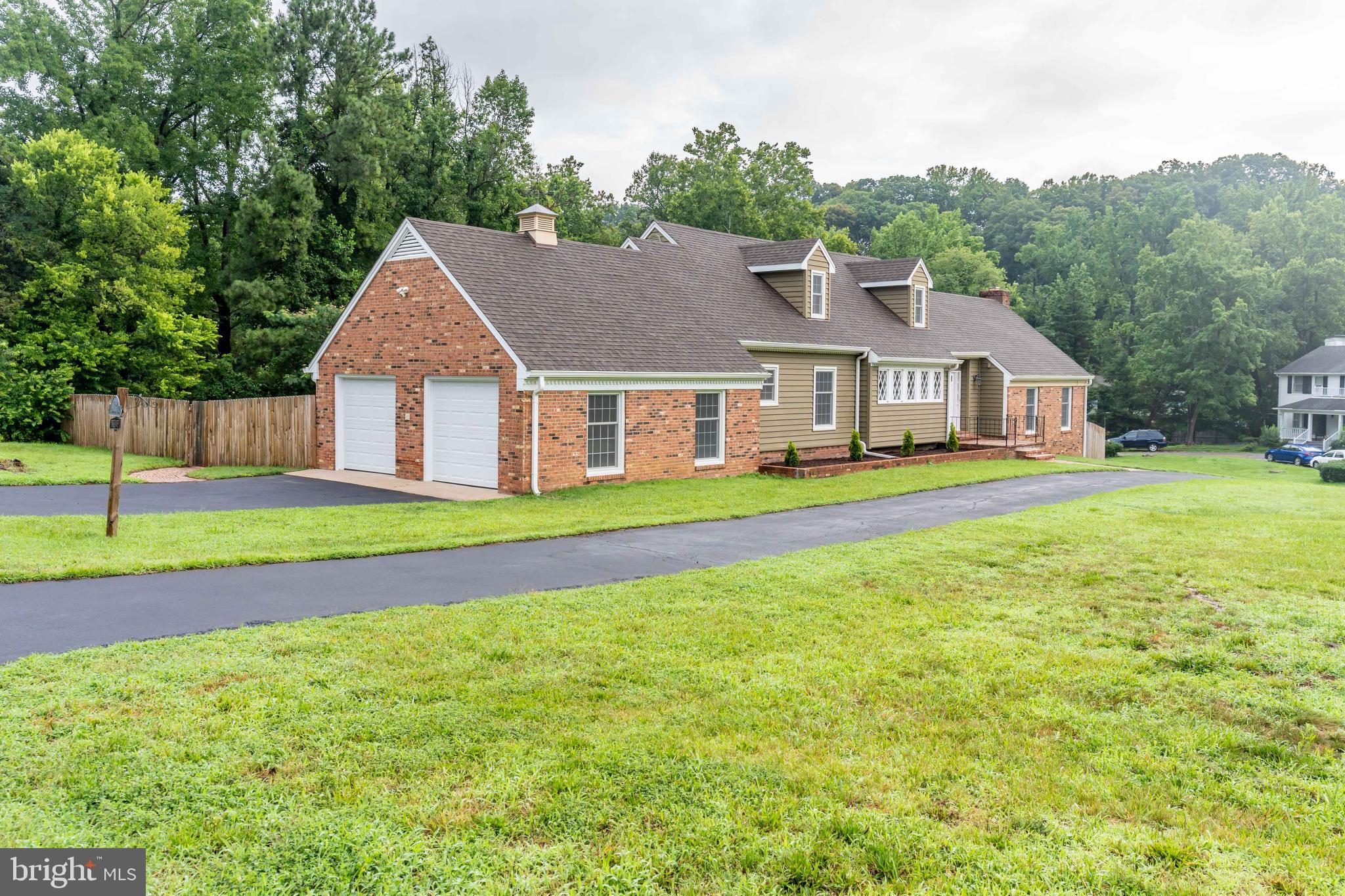 142 Woodland Road Fredericksburg, VA 22401 - Photo 1 of 49 a front view of a house with a yard and trees