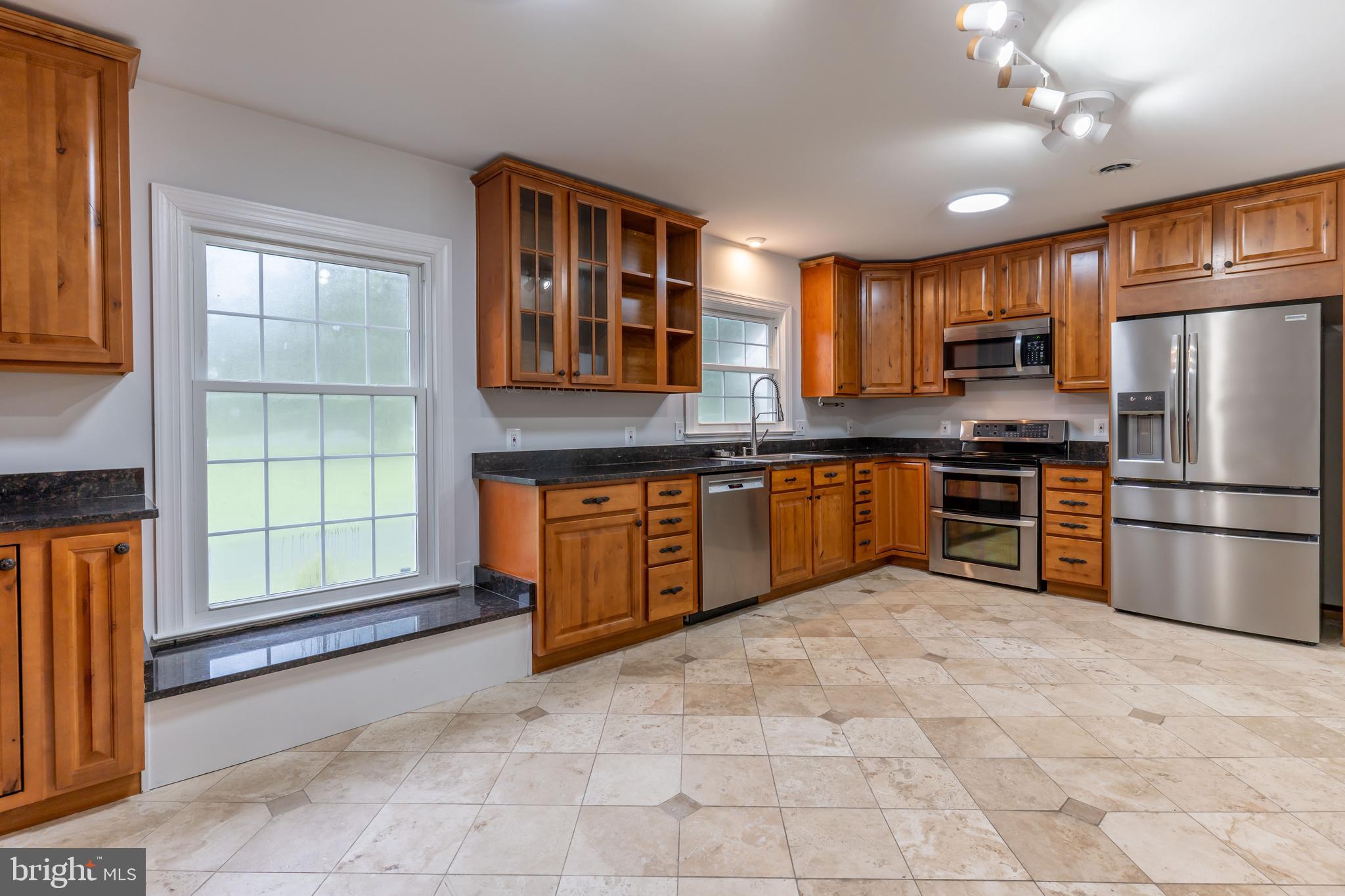 142 Woodland Road Fredericksburg, VA 22401 - Photo 11 of 49 a kitchen with stainless steel appliances granite countertop a refrigerator and a sink