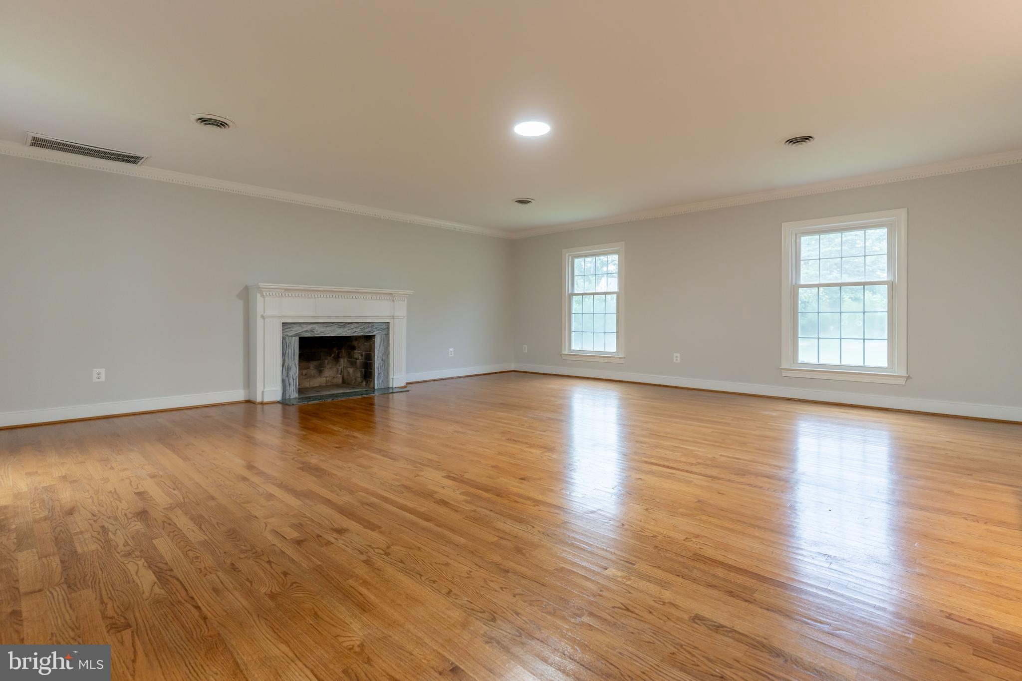 142 Woodland Road Fredericksburg, VA 22401 - Photo 17 of 49 an empty room with wooden floor fireplace and windows