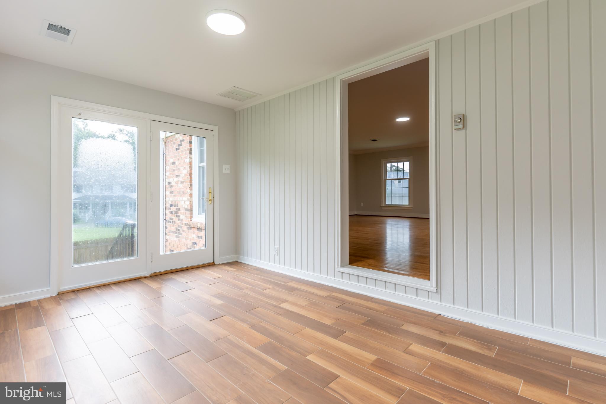 142 Woodland Road Fredericksburg, VA 22401 - Photo 22 of 49 a view of an empty room with glass door and a window