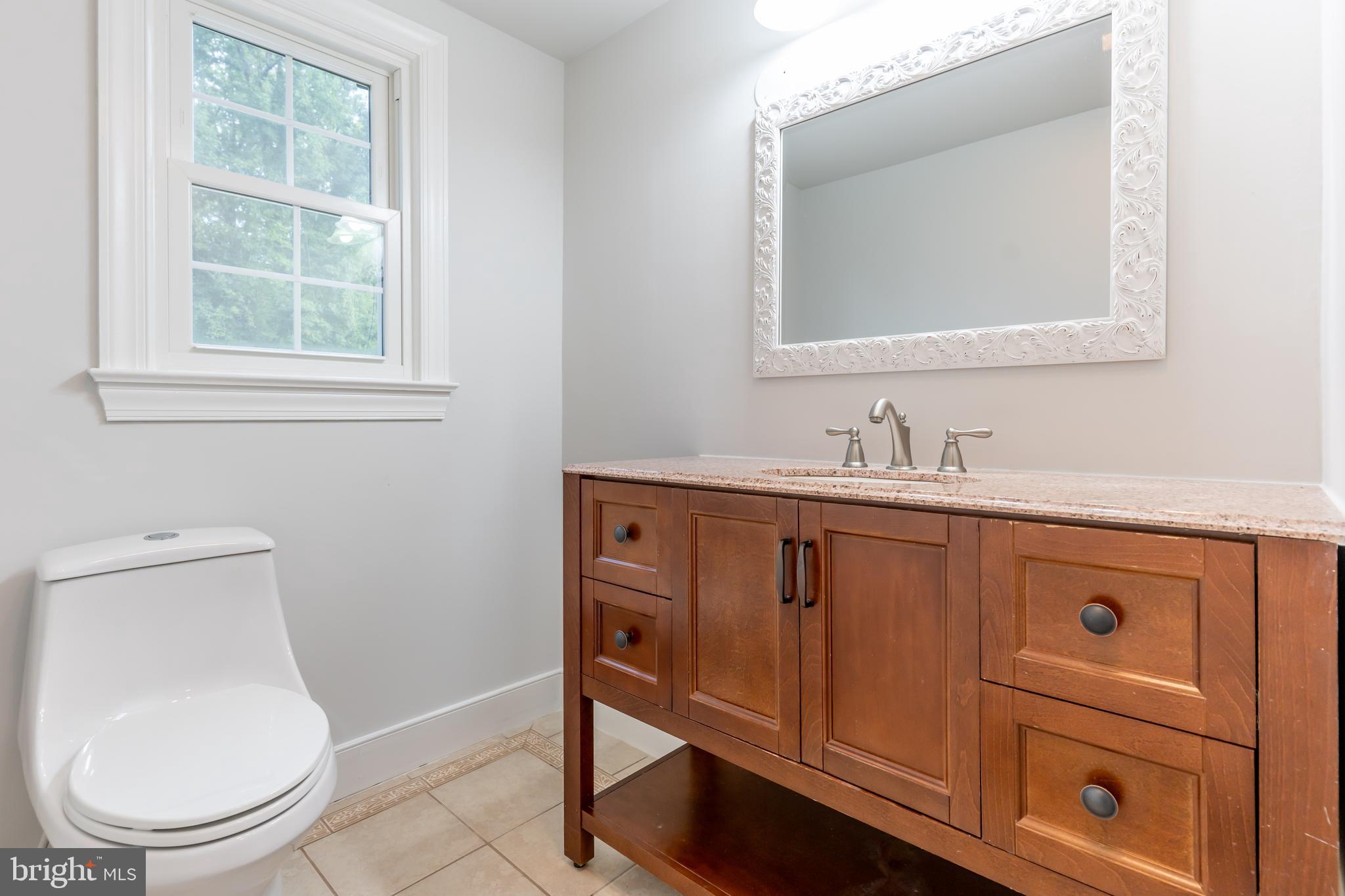 142 Woodland Road Fredericksburg, VA 22401 - Photo 23 of 49 a bathroom with a toilet sink vanity and mirror