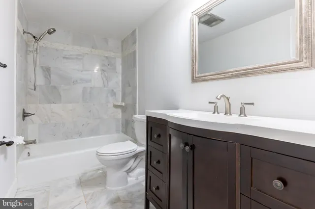 a bathroom with a sink a toilet and a bathtub