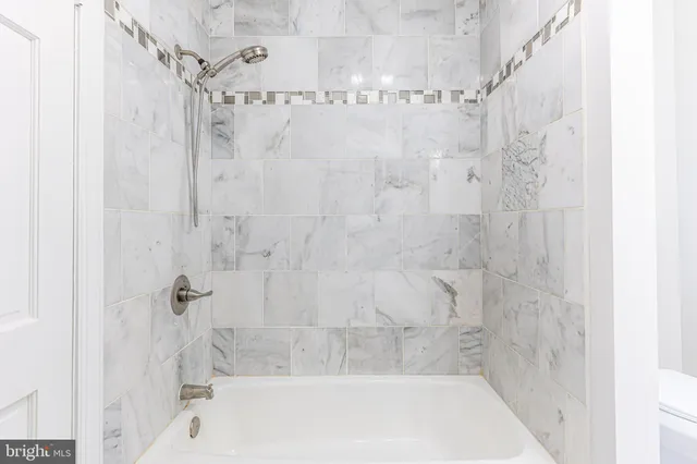 a bathroom with a shower and a bath tub