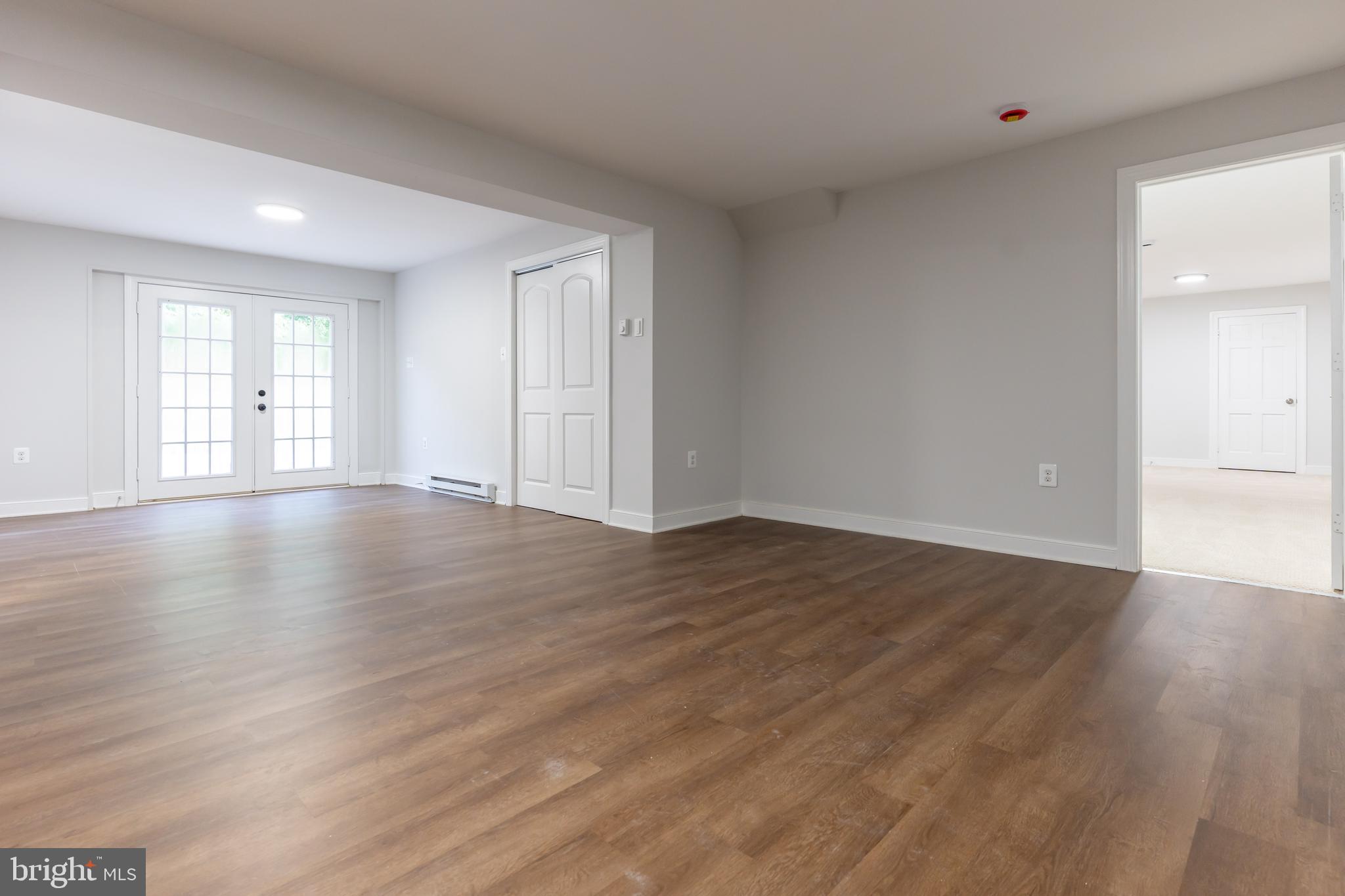 142 Woodland Road Fredericksburg, VA 22401 - Photo 41 of 49 a view of an empty room with wooden floor and windows
