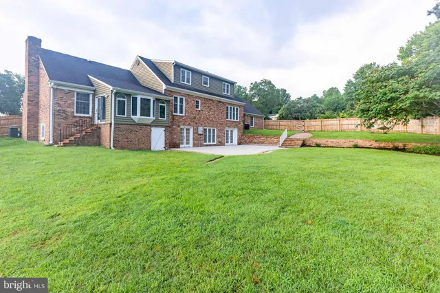 a view of a house with a yard and sitting area