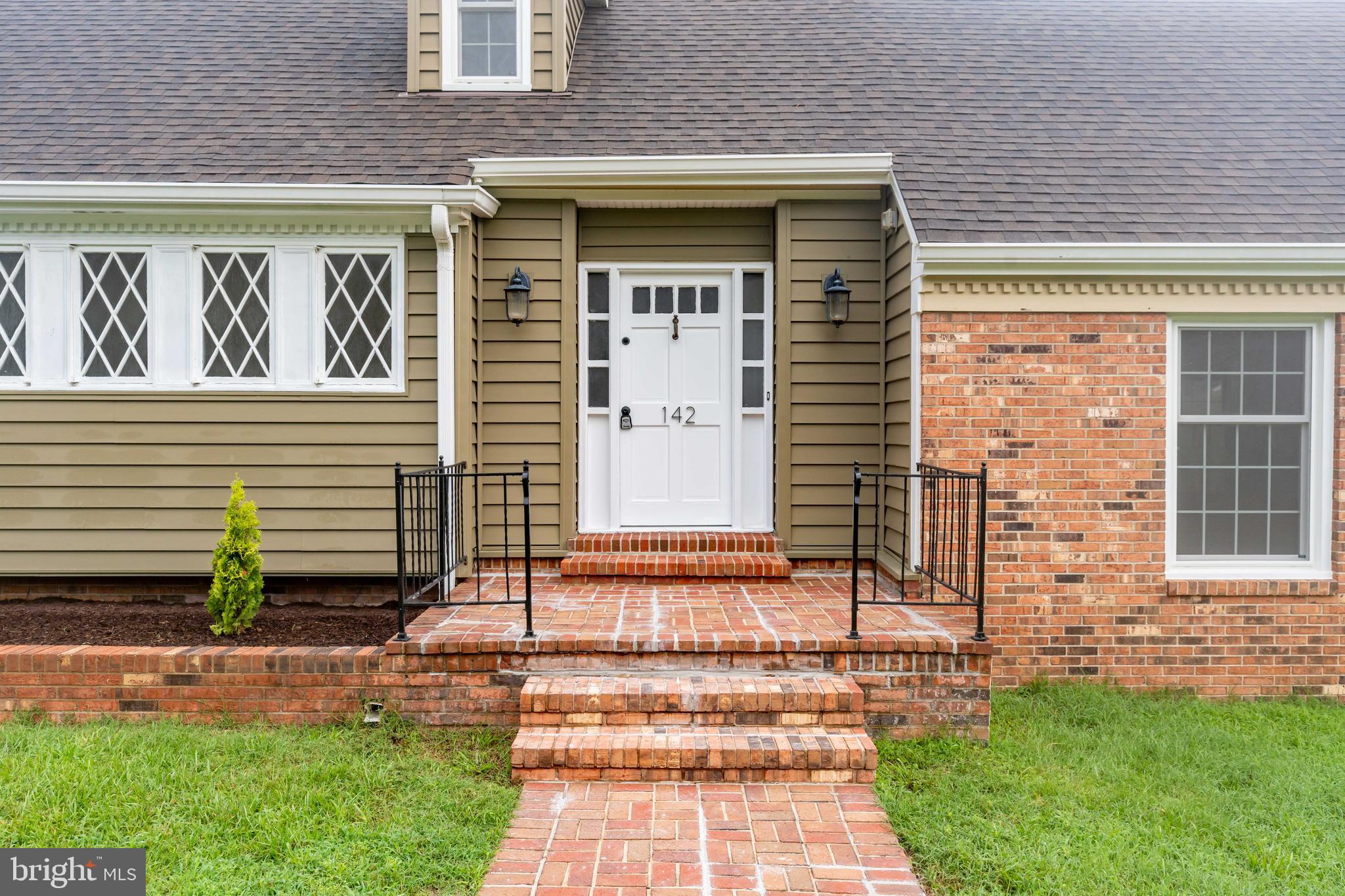 142 Woodland Road Fredericksburg, VA 22401 - Photo 6 of 49 a front view of a house with a garden