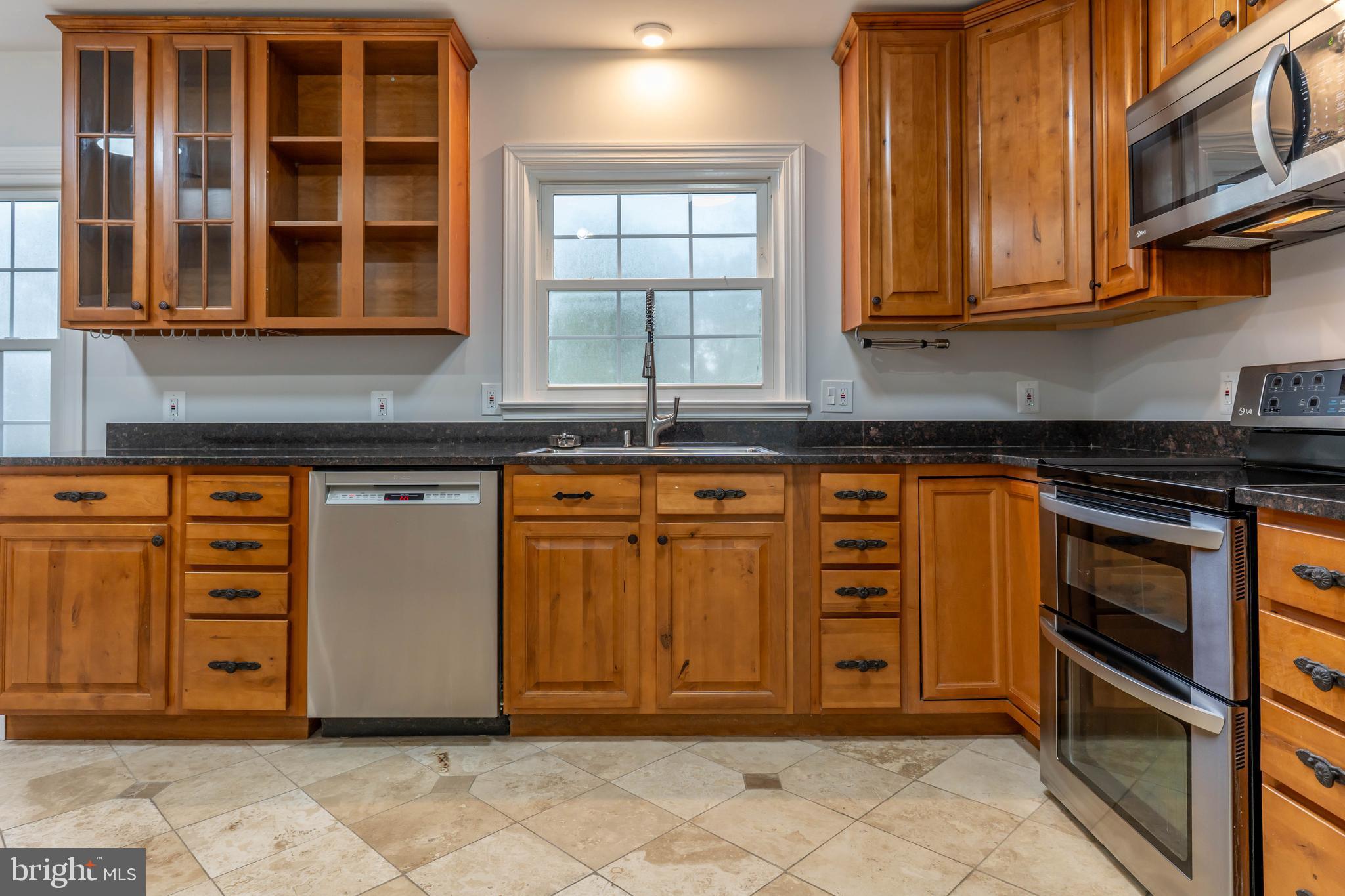 142 Woodland Road Fredericksburg, VA 22401 - Photo 7 of 49 a view of a kitchen with stainless steel appliances granite countertop a stove and cabinets