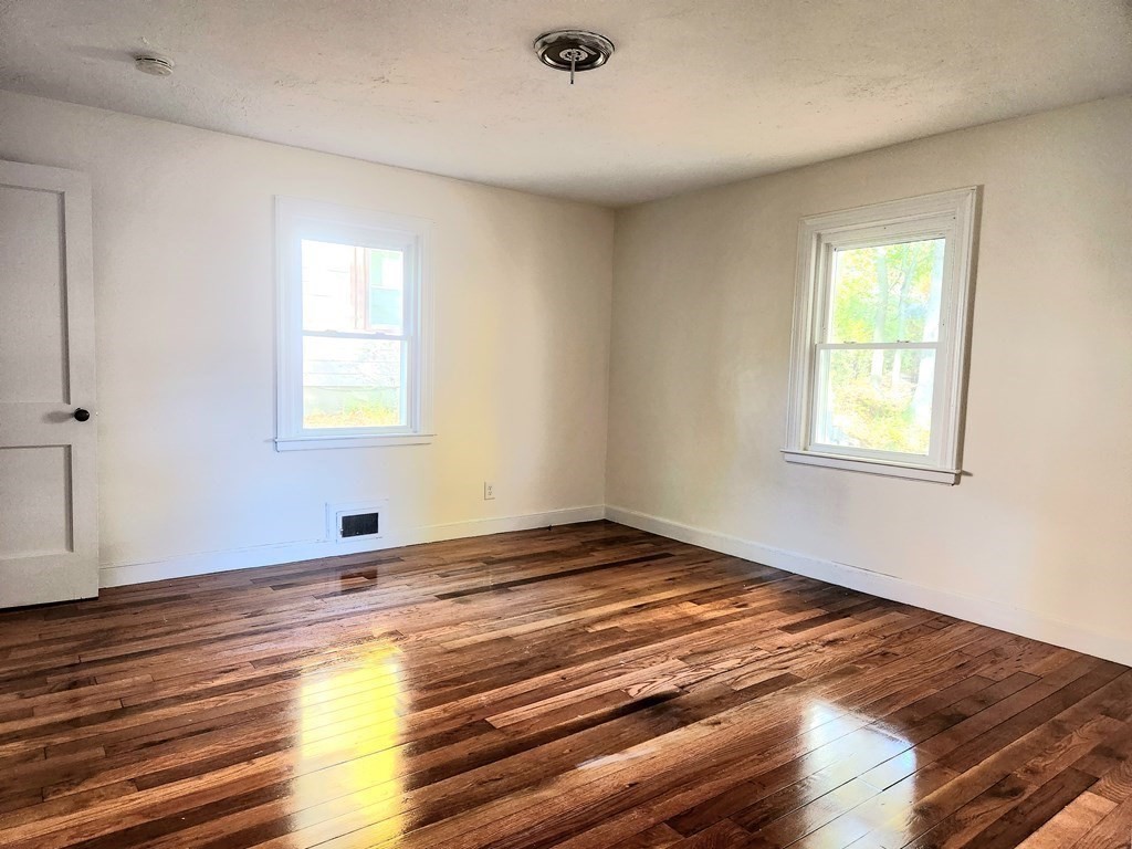 4 Pomona Road Worcester, MA 01602 - Photo 12 of 19 a view of an empty room with wooden floor and a window