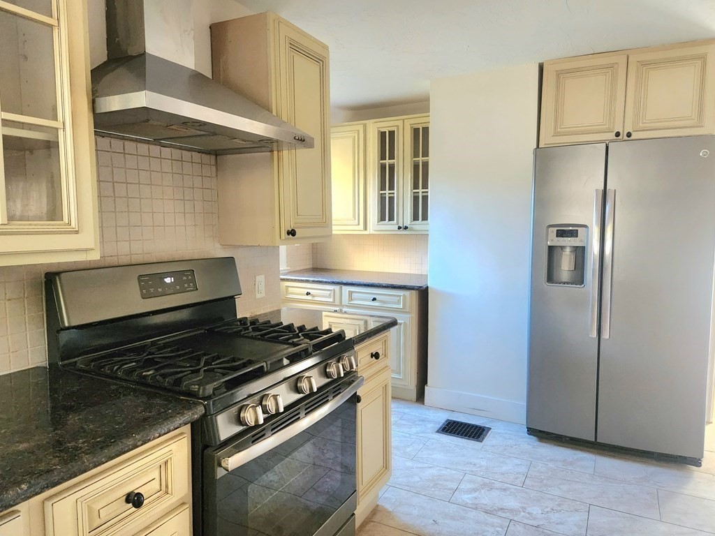 4 Pomona Road Worcester, MA 01602 - Photo 8 of 19 a kitchen with stainless steel appliances granite countertop a stove and a refrigerator
