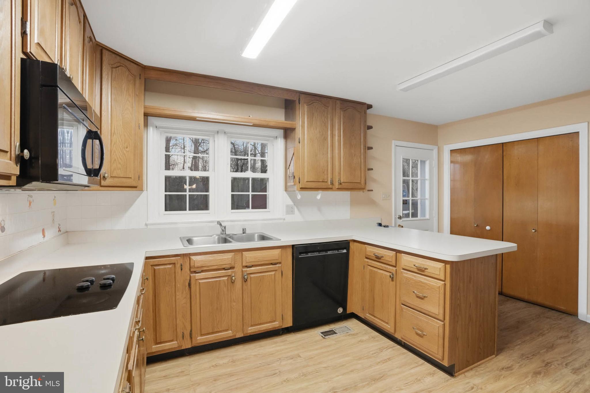 5407 Solomons Island Road Lothian, MD 20711 - Photo 12 of 42 a kitchen with a sink stove and cabinets