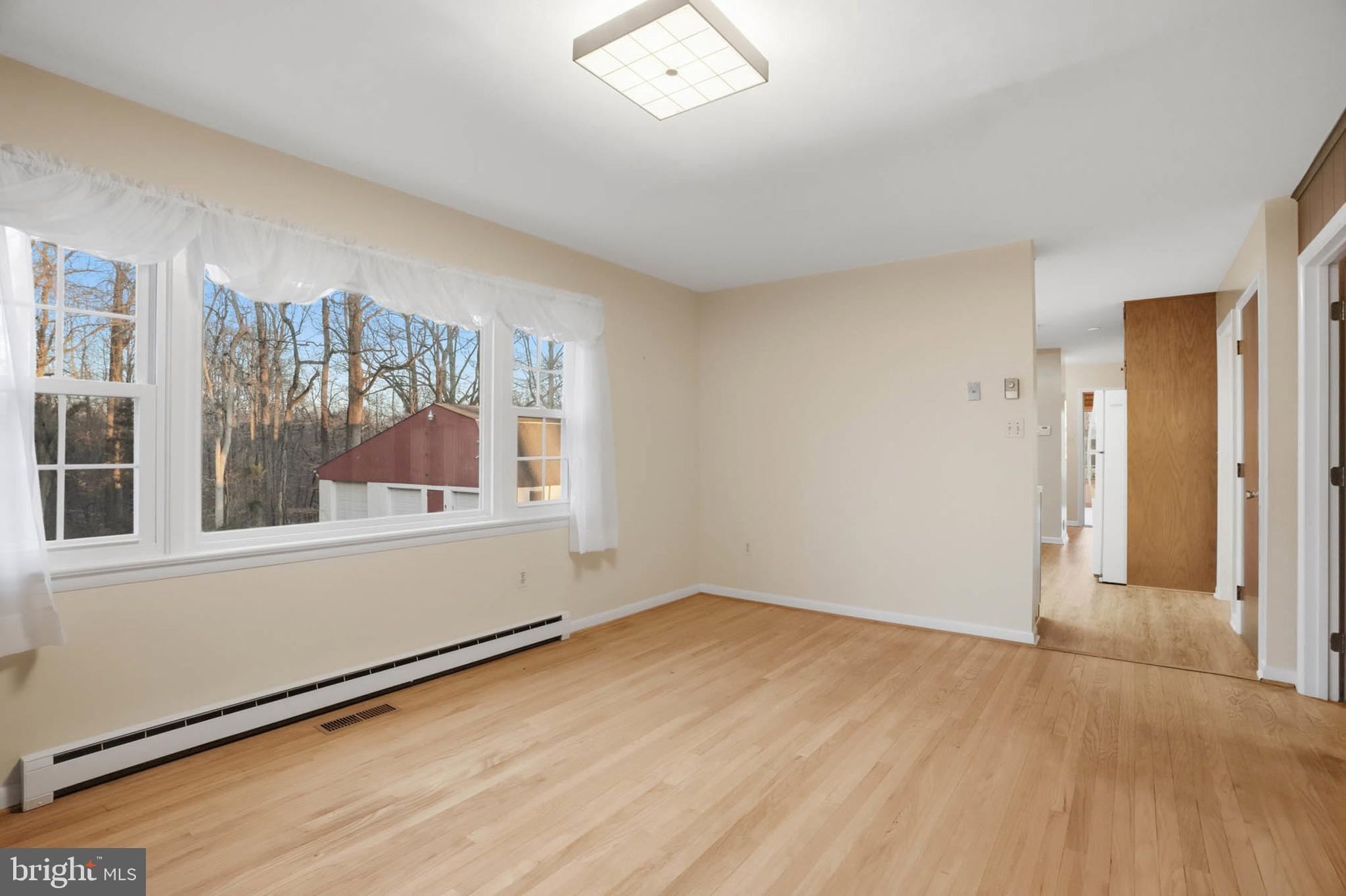 5407 Solomons Island Road Lothian, MD 20711 - Photo 18 of 42 an empty room with wooden floor and windows