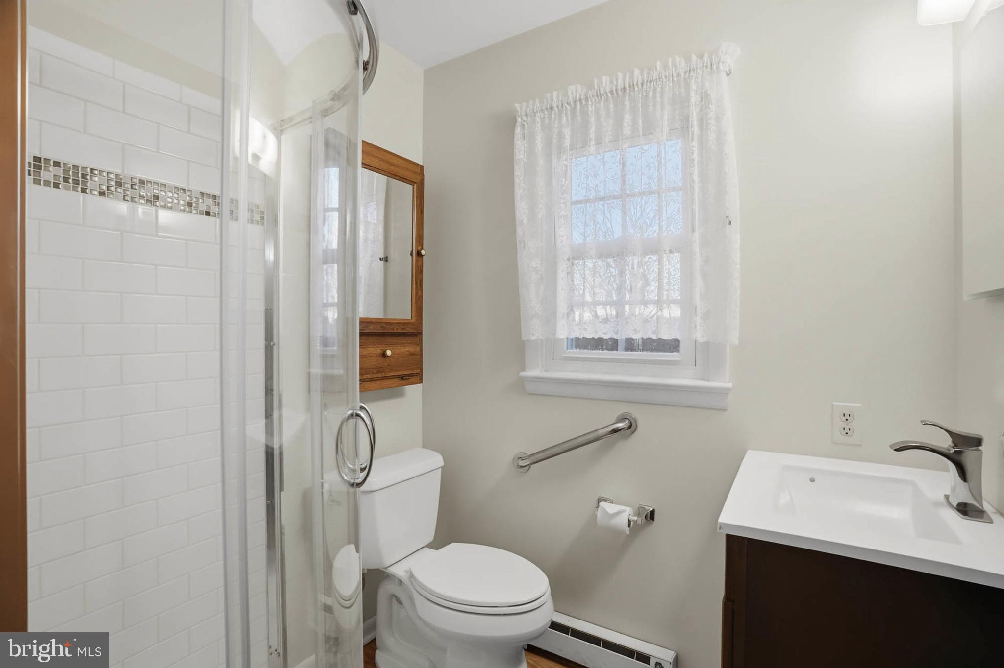 5407 Solomons Island Road Lothian, MD 20711 - Photo 20 of 42 a bathroom with a sink a toilet and shower