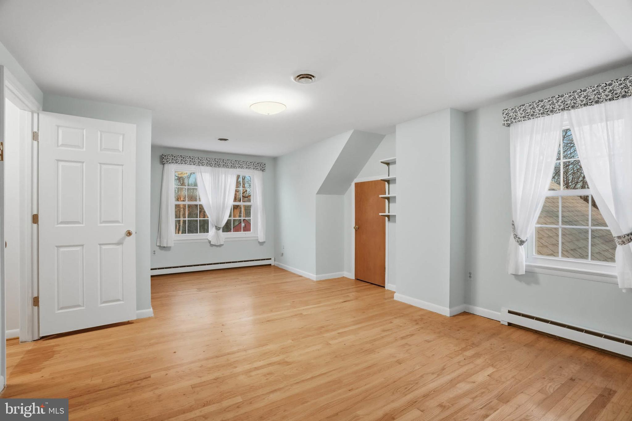 5407 Solomons Island Road Lothian, MD 20711 - Photo 21 of 42 a view of an empty room with a window and wooden floor