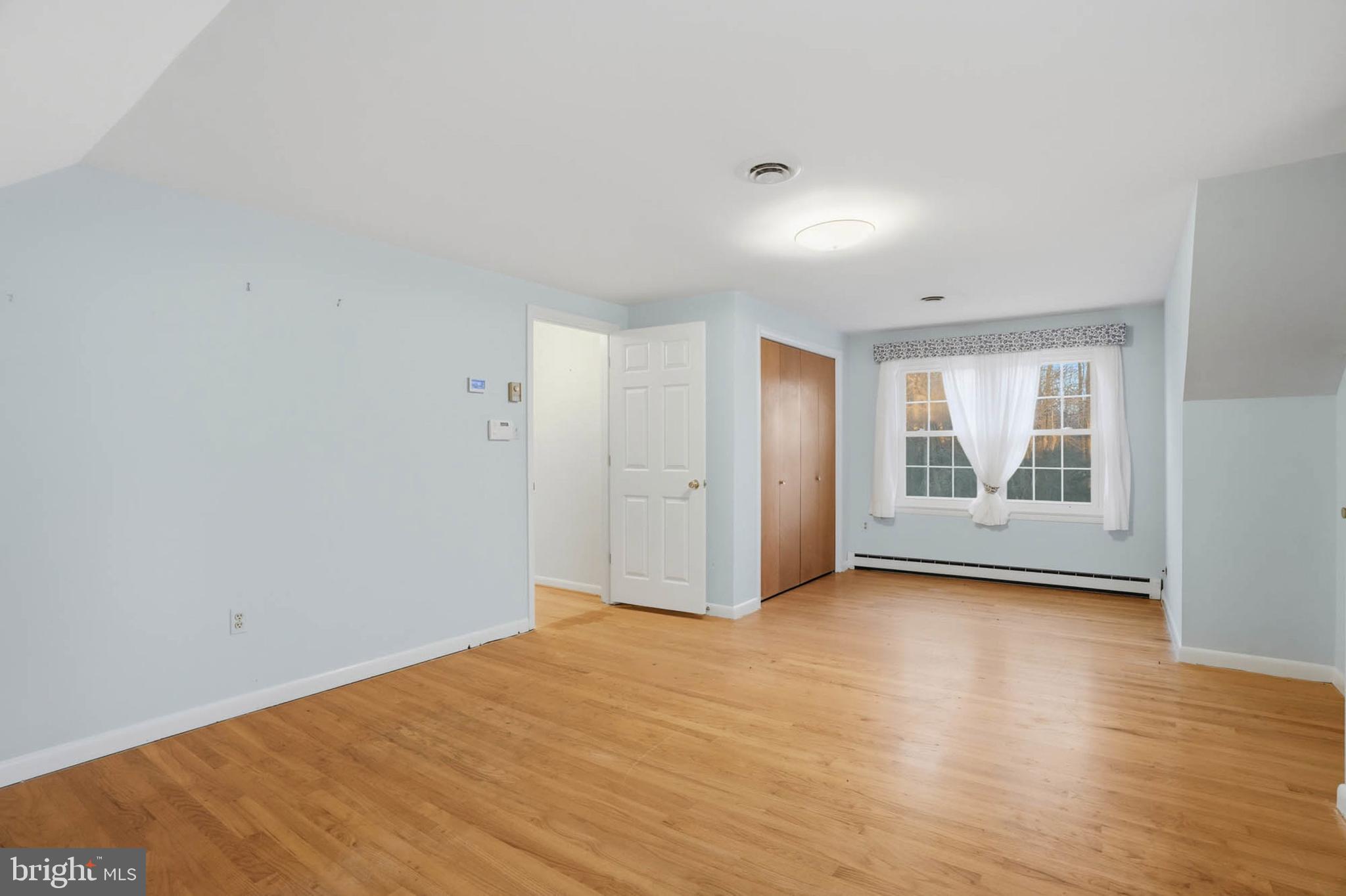 5407 Solomons Island Road Lothian, MD 20711 - Photo 22 of 42 a view of an empty room with wooden floor and a window