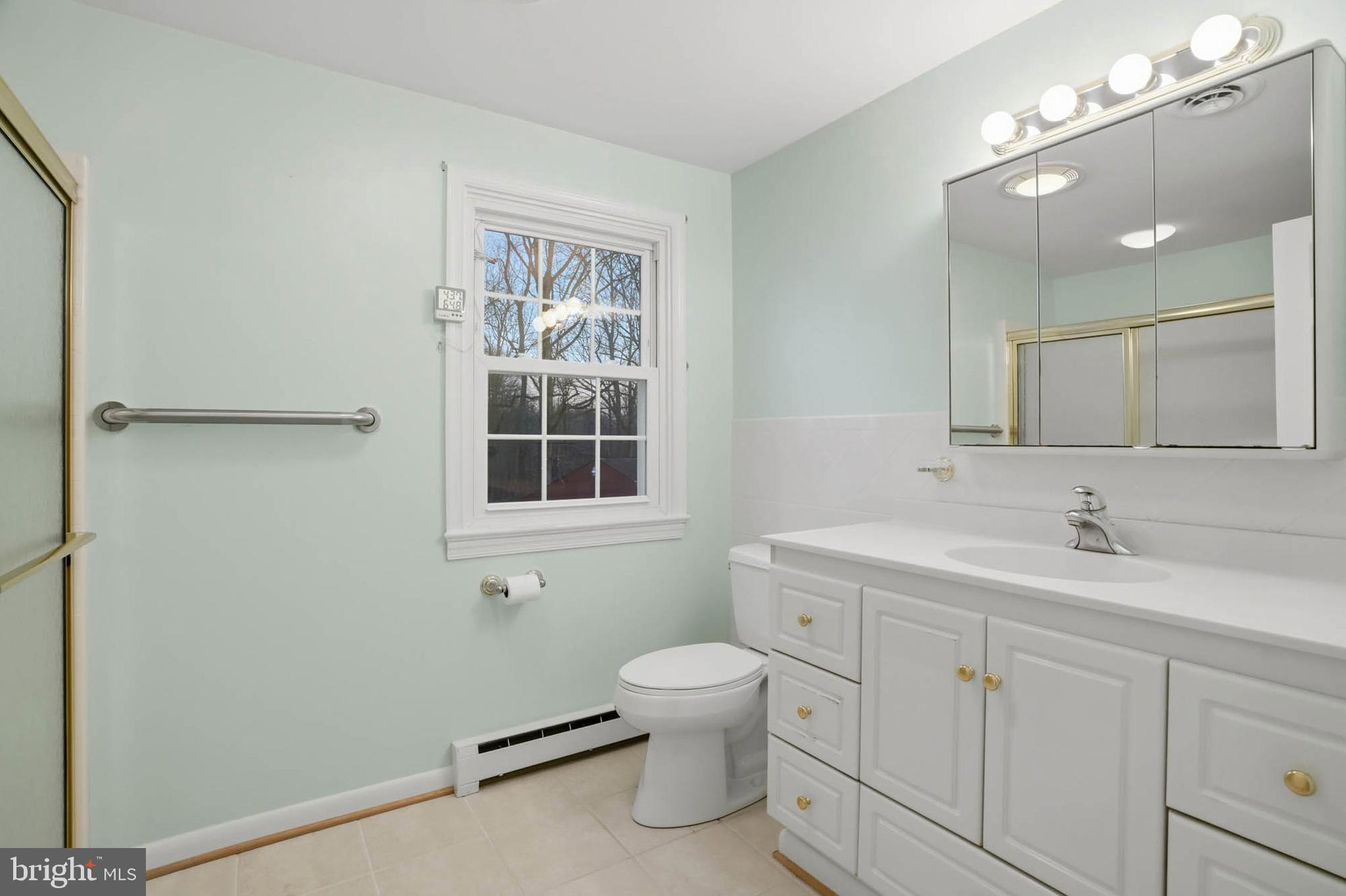 5407 Solomons Island Road Lothian, MD 20711 - Photo 23 of 42 a bathroom with a toilet a sink and mirror