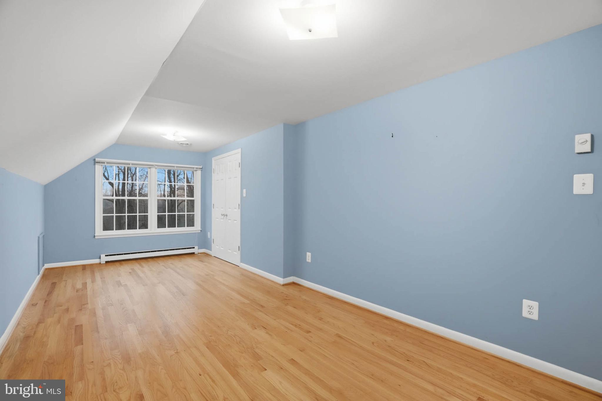 5407 Solomons Island Road Lothian, MD 20711 - Photo 24 of 42 a view of an empty room with wooden floor and a window