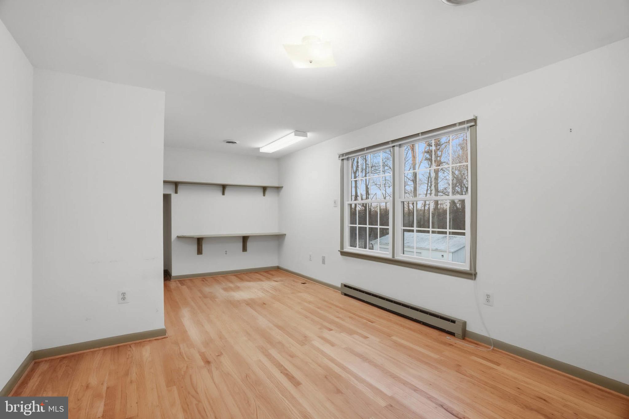 5407 Solomons Island Road Lothian, MD 20711 - Photo 26 of 42 an empty room with wooden floor and windows