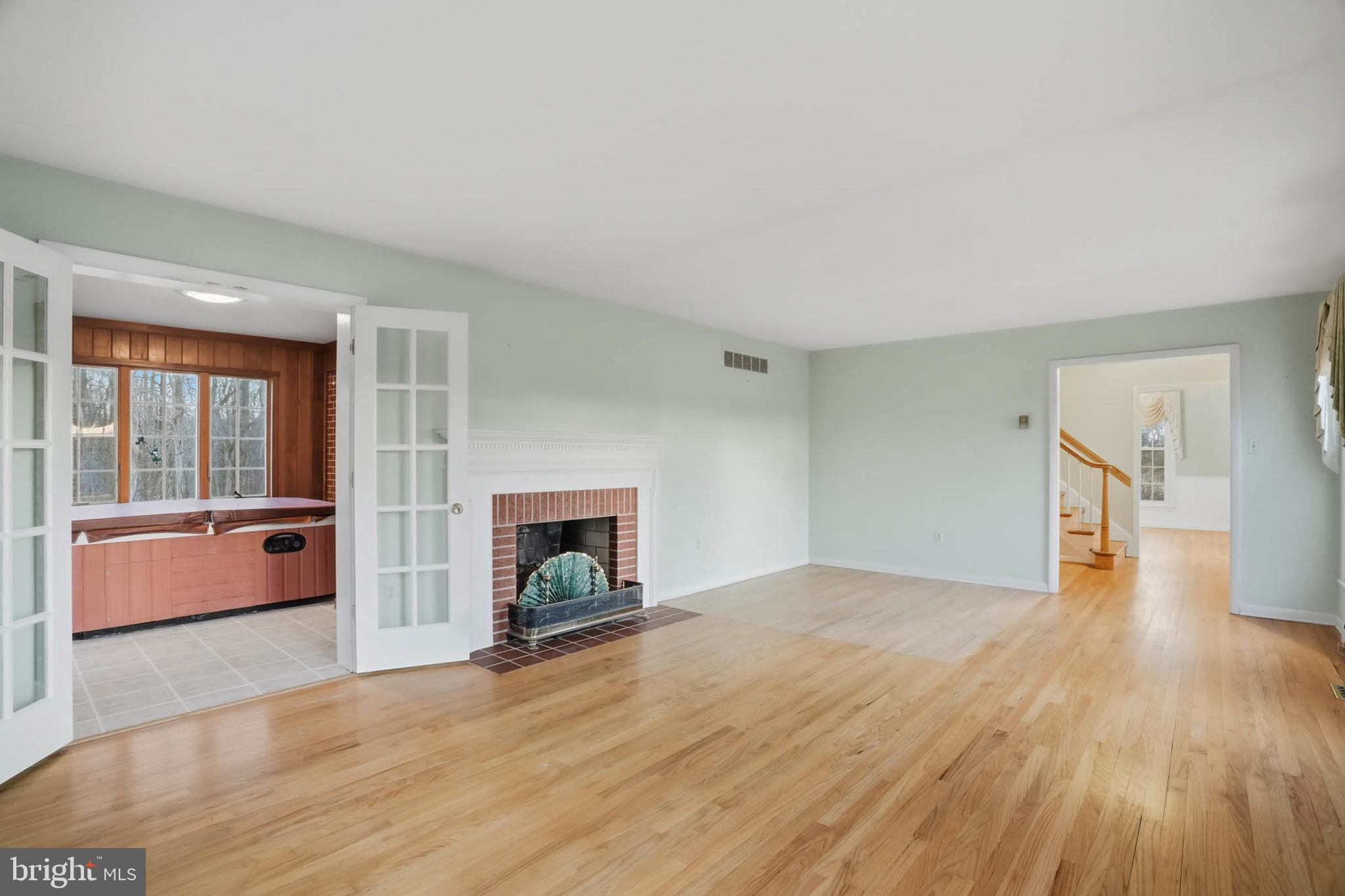 5407 Solomons Island Road Lothian, MD 20711 - Photo 8 of 42 a view of empty room with wooden floor and fireplace
