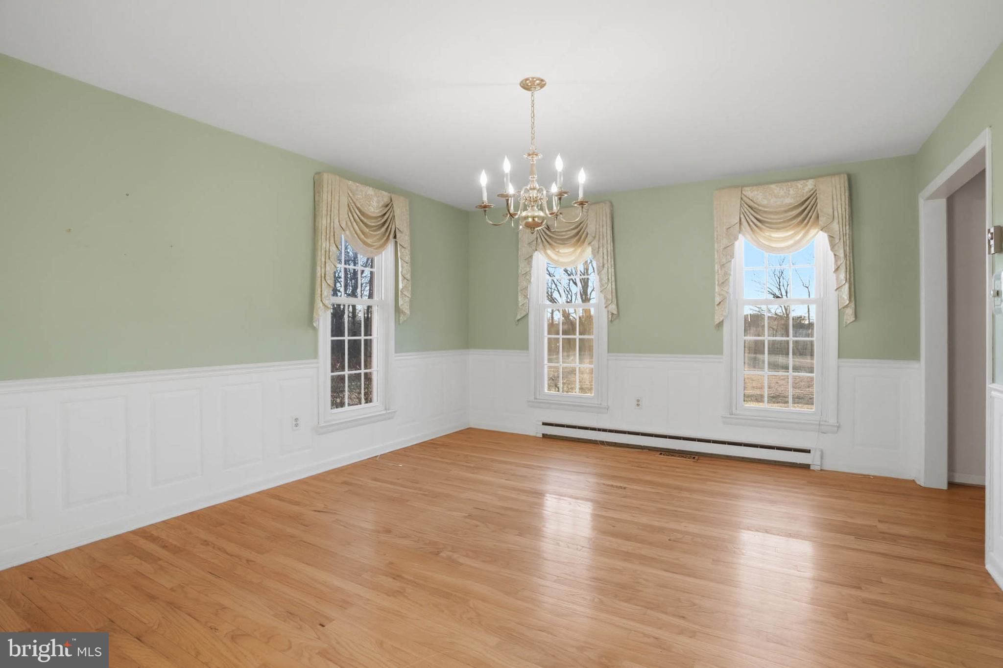 5407 Solomons Island Road Lothian, MD 20711 - Photo 10 of 42 a view of an empty room with wooden floor and a window
