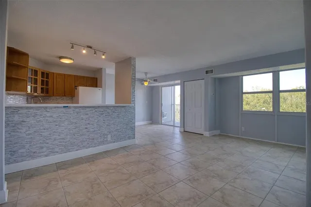 a view of an empty room and a window