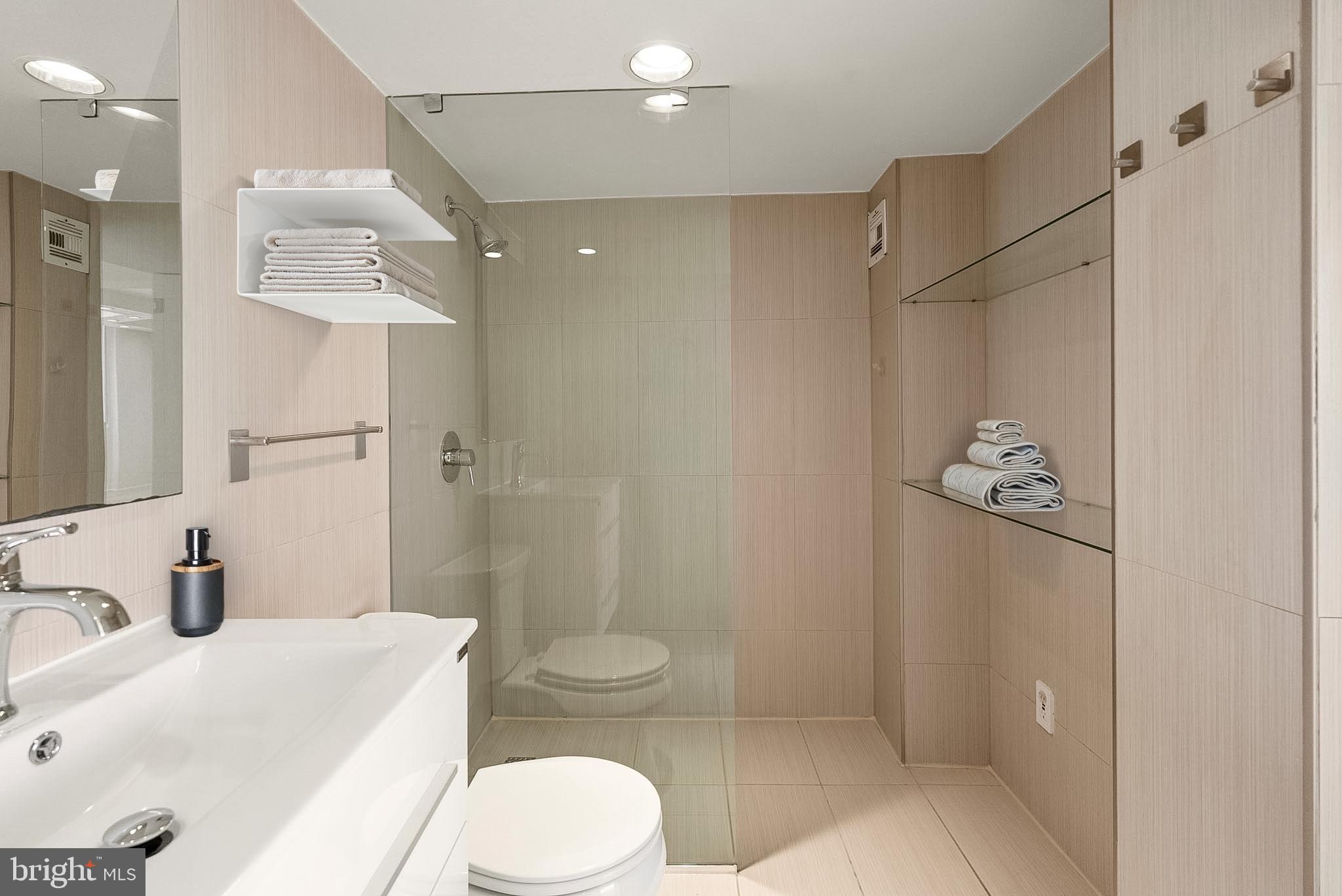 1718 P Street Northwest, Unit 902 Washington, DC 20036 - Photo 11 of 17 a bathroom with a sink a toilet and shower