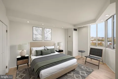 a bedroom with a bed and a large window