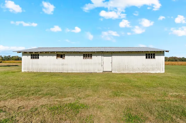a view of a big room with wooden floor and windows