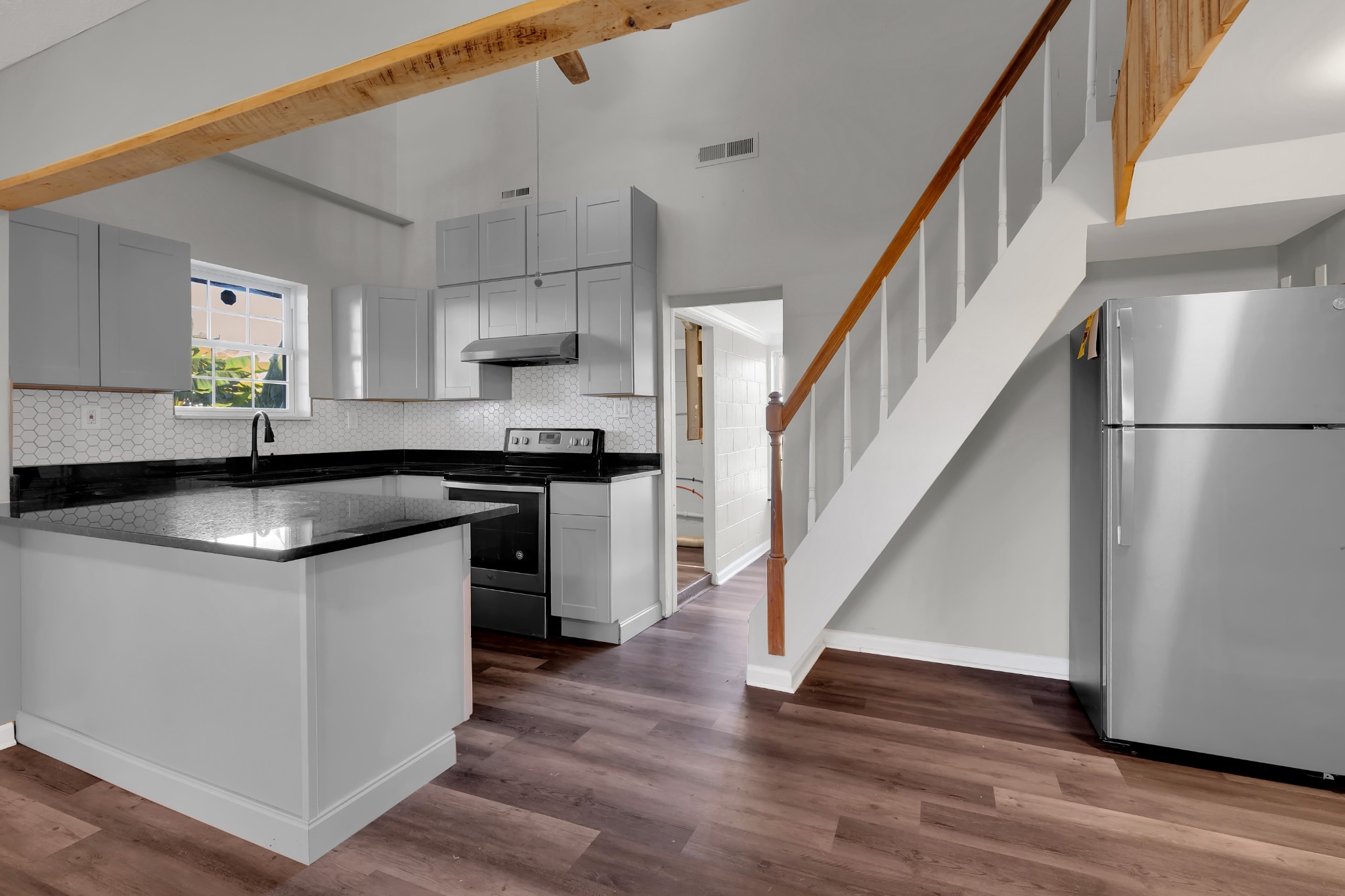 490 Shady Grove Road Manchester, TN 37355 - Photo 25 of 49 a kitchen with stainless steel appliances granite countertop a sink a stove a refrigerator and island with wooden floor