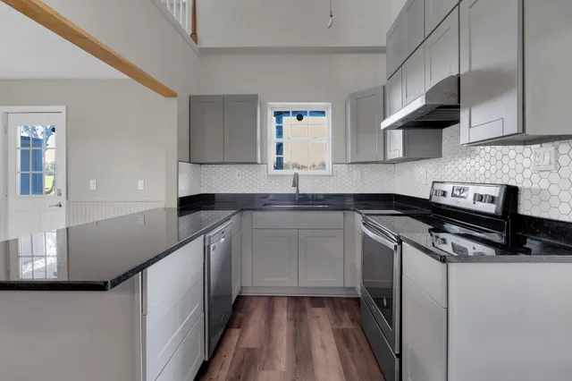 a kitchen with a sink cabinets and stainless steel appliances