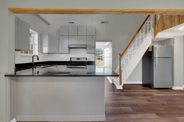 a kitchen with kitchen island a counter top space and cabinets